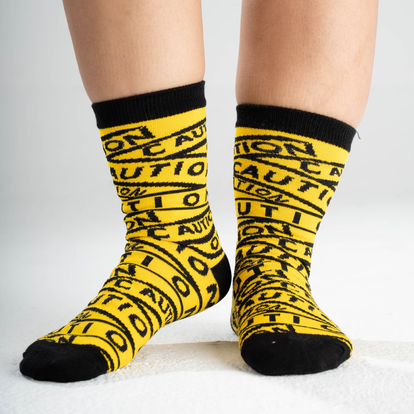 Flat lay of Dank N Drip Caution Socks on white background – premium cotton streetwear socks for men and women